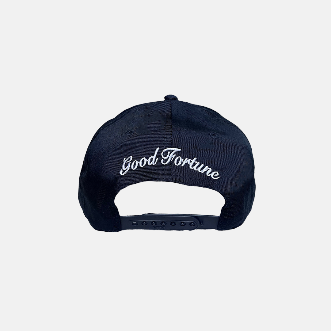 Navy Blue Trucker Hat with a White Logo on the Front, Adjustable Strap, Curved Brim, and Good Fortune curved in the back